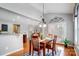 Charming dining area with wood floors is adjacent to an open doorway to the living room at 3350 Keady Mill Loop, Kannapolis, NC 28081