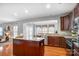 Bright kitchen boasts a large island with granite countertops, stainless steel appliances, and wood floors at 3350 Keady Mill Loop, Kannapolis, NC 28081