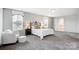 Bright main bedroom featuring large windows and sitting area with comfy chair at 3350 Keady Mill Loop, Kannapolis, NC 28081