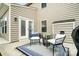 Relaxing back patio area with outdoor seating, blue rug and landscaped backyard at 3350 Keady Mill Loop, Kannapolis, NC 28081