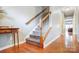 Staircase with wooden handrail, carpet steps, and hardwood floors at 3350 Keady Mill Loop, Kannapolis, NC 28081
