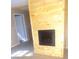 Living room features a knotty pine fireplace and light wood-look floors at 336 Hudson St, Shelby, NC 28150