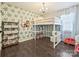 Cozy bedroom with a loft bed, a built in desk, and decorative wallpaper at 4021 Waterford Dr, Charlotte, NC 28226