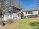 Charming exterior with a gray brick facade, blue siding, a well-manicured lawn, and a two-car garage at 4021 Waterford Dr, Charlotte, NC 28226