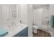 Updated bathroom features a vanity with marble countertop, a shower and tub at 407 E Talleyrand St, Monroe, NC 28112