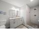 Updated bathroom with double vanity, granite countertops, and walk-in shower at 407 E Talleyrand St, Monroe, NC 28112