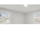 Bright bedroom featuring white walls, two windows with blinds, and recessed lighting at 407 E Talleyrand St, Monroe, NC 28112