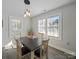 Sunlit dining area with modern light fixtures and views of the surrounding neighborhood at 407 E Talleyrand St, Monroe, NC 28112
