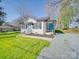 Quaint single-story home boasts a bright blue door, covered porch, and a lush green lawn at 407 E Talleyrand St, Monroe, NC 28112