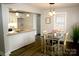 Open concept kitchen and dining area with modern lighting fixtures and granite countertops at 407 E Talleyrand St, Monroe, NC 28112
