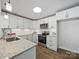 Modern kitchen with white cabinets, stainless steel appliances, and granite countertops at 407 E Talleyrand St, Monroe, NC 28112