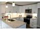 Modern kitchen featuring white cabinets, subway tile backsplash, and stainless steel appliances at 407 E Talleyrand St, Monroe, NC 28112