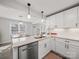 Bright kitchen features white cabinets, stainless steel appliances, and granite countertops at 407 E Talleyrand St, Monroe, NC 28112