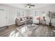 Bright living room featuring a gray sectional sofa, decorative pillows, and natural light at 407 E Talleyrand St, Monroe, NC 28112