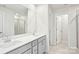 Bright bathroom featuring double sink vanity, a large mirror, and a glass-enclosed shower at 410 Luna Ln, Shelby, NC 28152