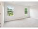Bright, spacious bedroom features neutral carpet, trim and paint, and two windows at 410 Luna Ln, Shelby, NC 28152