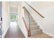 Inviting entryway showcasing a staircase with wooden banister and sleek laminate flooring at 410 Luna Ln, Shelby, NC 28152