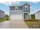 Charming two-story home featuring a two-car garage and a beautifully landscaped front yard at 410 Luna Ln, Shelby, NC 28152