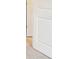 Hallway with a partial view of a door and carpeted floors, enhancing the home's cohesive design at 410 Luna Ln, Shelby, NC 28152