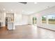 Open living space with stainless appliances, laminate floors, island, and sliding glass doors at 410 Luna Ln, Shelby, NC 28152