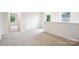 Upstairs loft area with plush carpeting and two windows creating a relaxing retreat at 410 Luna Ln, Shelby, NC 28152