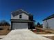 Two-story home features a two-car garage, concrete driveway and manicured lawn set beneath a clear blue sky at 412 Luna Ln, Shelby, NC 28152