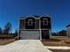 Charming two-story home featuring a two-car garage and modern architectural details at 414 Luna Ln, Shelby, NC 28152