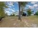 Spacious backyard with mature trees, providing ample shade and privacy for outdoor enjoyment at 4660 Ardmore Ln, Harrisburg, NC 28075