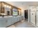 Spacious bathroom with dual vanities, decorative wallpaper, and a large walk-in shower at 4660 Ardmore Ln, Harrisburg, NC 28075
