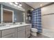 Modern bathroom features a double sink vanity, gray walls, tile floors, and a bathtub with a shower at 4660 Ardmore Ln, Harrisburg, NC 28075