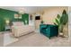 Comfortable bedroom with a plush bed, accent chair, and serene decor at 4660 Ardmore Ln, Harrisburg, NC 28075