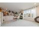 Bright bonus room features a faux brick accent wall, white cabinets, and natural light from large windows at 4660 Ardmore Ln, Harrisburg, NC 28075