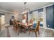 Elegant dining room with a large wooden table, chandelier, and plenty of natural light at 4660 Ardmore Ln, Harrisburg, NC 28075