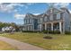 Two story home with a well-manicured lawn, showcasing a charming curb appeal and inviting entrance at 4660 Ardmore Ln, Harrisburg, NC 28075