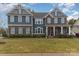 Two story home with stone accents, showcasing a charming curb appeal and inviting entrance at 4660 Ardmore Ln, Harrisburg, NC 28075