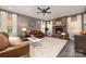 Comfortable living room features a stone fireplace, hardwood floors, and ample natural light, creating a relaxing atmosphere at 4660 Ardmore Ln, Harrisburg, NC 28075