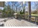 This back deck features a grill and offers an outdoor living space at 4820 Valley Stream Rd, Charlotte, NC 28209