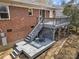 The home's backyard features a two tiered deck and brick exterior at 4820 Valley Stream Rd, Charlotte, NC 28209