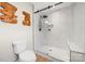 Modern bathroom with white tile shower, glass door, rainfall shower head, and sleek fixtures at 4820 Valley Stream Rd, Charlotte, NC 28209