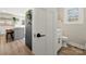 Bright bathroom with a modern toilet, and a view to the kitchen with wooden floor at 4820 Valley Stream Rd, Charlotte, NC 28209