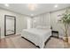 Cozy bedroom with a large bed, mirror, an area rug and natural light coming through the window at 4820 Valley Stream Rd, Charlotte, NC 28209