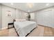 This bedroom features hardwood floors, a modern lighting fixture and a large closet at 4820 Valley Stream Rd, Charlotte, NC 28209