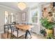 Bright dining room featuring a modern chandelier, decor, and a window for natural lighting at 4820 Valley Stream Rd, Charlotte, NC 28209