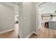 Hallway view of the kitchen, featuring grey cabinets, wooden floor and a view of the livingroom at 4820 Valley Stream Rd, Charlotte, NC 28209