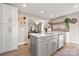Bright open kitchen with gray island, stainless steel appliances, and an open view to the dining area at 4820 Valley Stream Rd, Charlotte, NC 28209