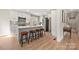Beautiful open-concept kitchen with a center island, modern appliances, and wood plank flooring at 4820 Valley Stream Rd, Charlotte, NC 28209