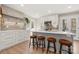 Bright and modern kitchen with an island, white cabinetry, updated appliances, and wood flooring at 4820 Valley Stream Rd, Charlotte, NC 28209