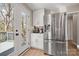 Kitchen area featuring modern refrigerator, stainless steel appliances, and access to a deck at 4820 Valley Stream Rd, Charlotte, NC 28209