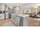 Bright, open-concept kitchen with stainless steel appliances and a view to the living and dining areas at 4820 Valley Stream Rd, Charlotte, NC 28209