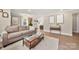 Cozy living room with a comfortable sofa, coffee table, and a view into the open kitchen at 4820 Valley Stream Rd, Charlotte, NC 28209